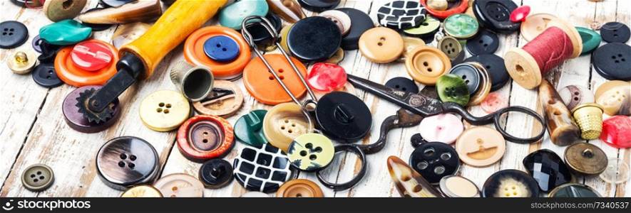 Spools of threads and buttons on wooden table.Scissor, sewing buttons and thread. Sewing tools and accessories