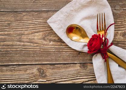 spoon fork with red flower napkin