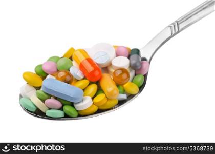 Spoon full of various colorful drugs isolated on white