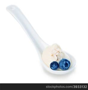Spoon of blueberry yogurt isolated on white