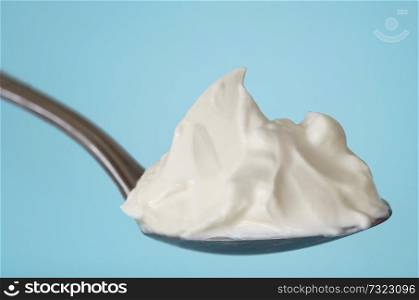 Spoon of Fresh yogurt in mountain shape