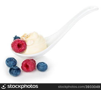 Spoon of raspberries and blueberries yogurt isolated on white