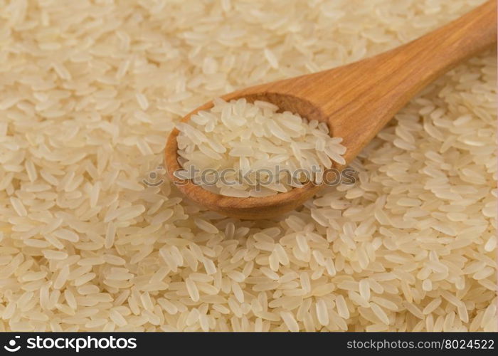 spoon of rice on puffed rice cereal background close up