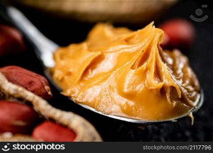 Spoon with peanut butter. Macro background. High quality photo. Spoon with peanut butter. Macro background.