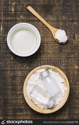 spoonfull with bowls coconut oil top view