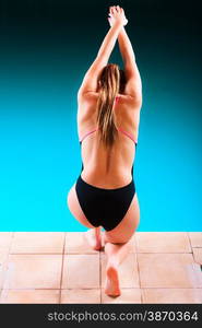 Sport active lifestyle. Sporty woman female swimmer muscular fit body preparing to jumping and diving into swimming pool back view