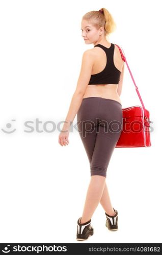 Sport and active lifestyle. Back of fitness sporty girl in sportswear with red gym bag isolated on white.