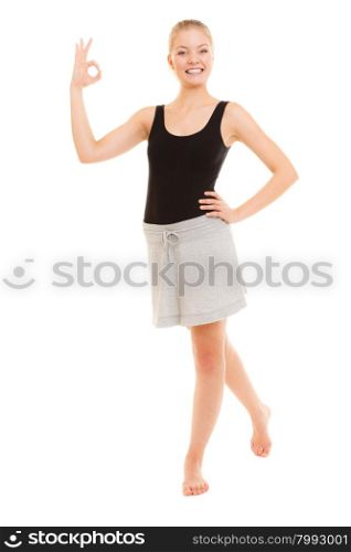 Sport and active lifestyle. Fitness sporty girl in sportswear showing ok okay hand sign gesture isolated on white