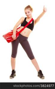 Sport and active lifestyle. Fitness sporty girl in sportswear with gym bag showing thumb up success hand sign gesture isolated on white