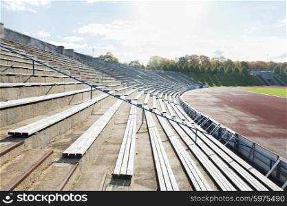 sport and architecture concept - stands with rows with benches on stadium. stands with rows of benches on stadium