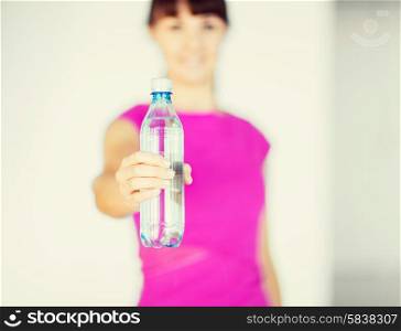 sport and diet concept - sporty woman with bottle of water