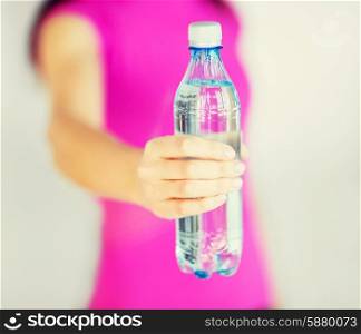 sport and diet concept - sporty woman with bottle of water