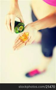 sport and diet concept - woman hand with medication
