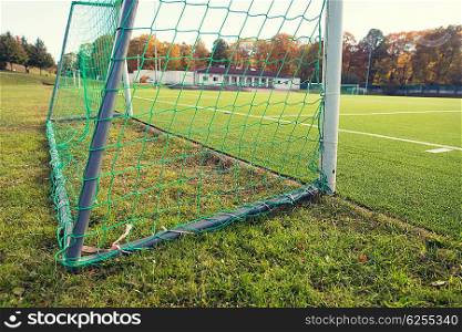 sport and equipment concept - close up of football goal on field. close up of football goal on field