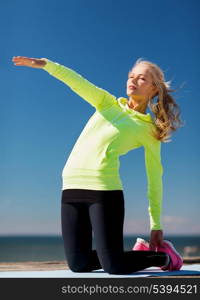 sport and lifestyle concept - woman doing sports outdoors