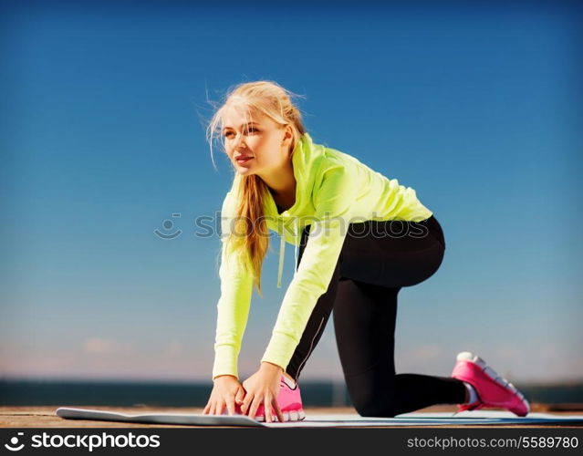 sport and lifestyle concept - woman doing sports outdoors