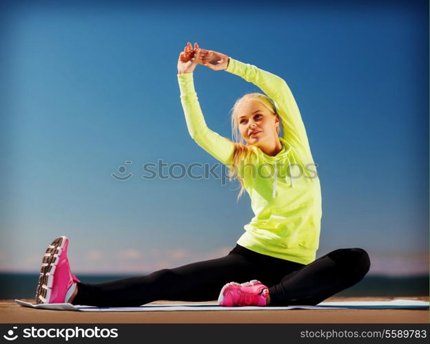 sport and lifestyle concept - woman doing sports outdoors