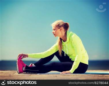 sport and lifestyle concept - woman doing sports outdoors