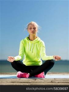 sport and lifestyle concept - woman doing yoga outdoors. woman doing yoga outdoors