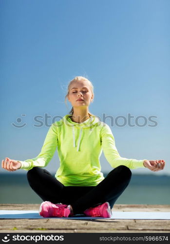 sport and lifestyle concept - woman doing yoga outdoors. woman doing yoga outdoors