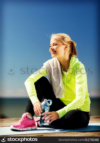 sport and lifestyle concept - woman resting after doing sports outdoors