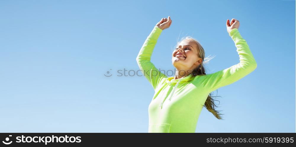 sport and lifestyle concept - woman runner celebrating victory. woman runner celebrating victory