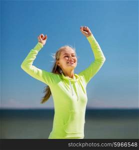 sport and lifestyle concept - woman runner celebrating victory. woman runner celebrating victory