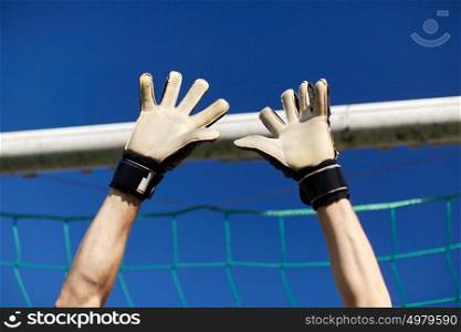 sport and people - soccer player or goalkeeper at football goal on field. goalkeeper or soccer player at football goal