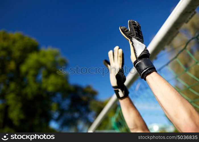 sport and people - soccer player or goalkeeper at football goal on field. goalkeeper or soccer player at football goal