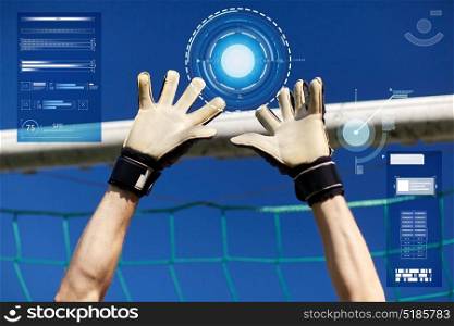 sport and technology concept - soccer player or goalkeeper hands at football goal. goalkeeper or soccer player hands at football goal