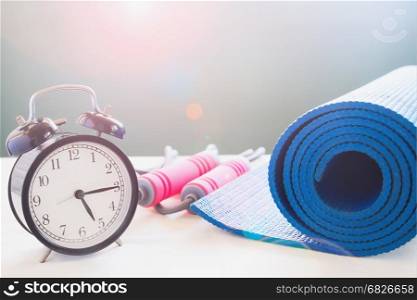 Sport and yoga equipments with alarm clock, Workout and healthy lifestyle concept with copy space