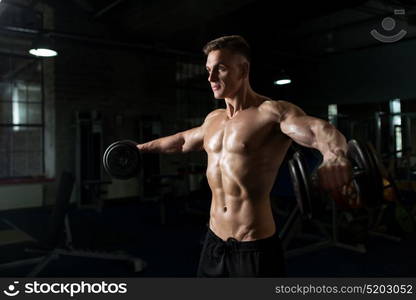 sport, bodybuilding, fitness and people concept - close up of young man with dumbbells flexing muscles in gym. close up of man with dumbbells exercising in gym