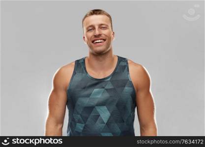 sport, bodybuilding, fitness and people concept - portrait of happy smiling young man or bodybuilder. portrait of smiling young man or bodybuilder