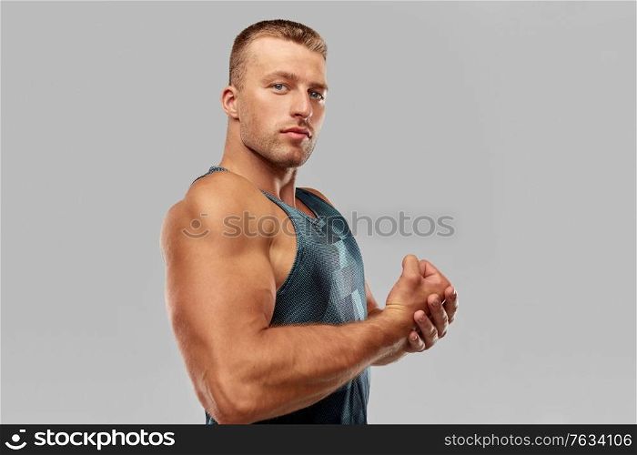sport, bodybuilding, fitness and people concept - portrait of young man or bodybuilder showing his muscles. portrait of young man or bodybuilder
