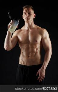 sport, bodybuilding, fitness and people concept - young man or bodybuilder with protein shake bottle and bare torso over black background. young man or bodybuilder with protein shake bottle