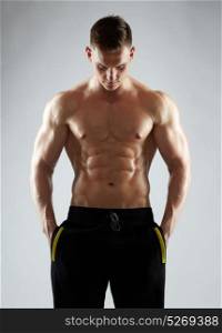 sport, bodybuilding, fitness and people concept - young man or bodybuilder with bare torso. young man or bodybuilder with bare torso
