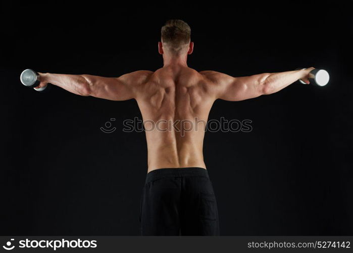 sport, bodybuilding, fitness and people concept - young man with dumbbells flexing muscles over black background from back. man with dumbbells exercising