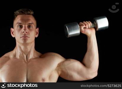 sport, bodybuilding, fitness and people concept - young man with dumbbells flexing muscles over black background. man with dumbbell exercising over black background