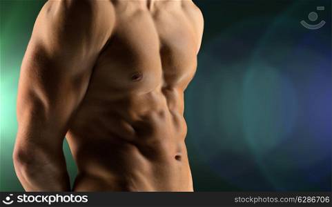 sport, bodybuilding, strength and people concept - cclose up of male bodybuilder bare torso over dark background