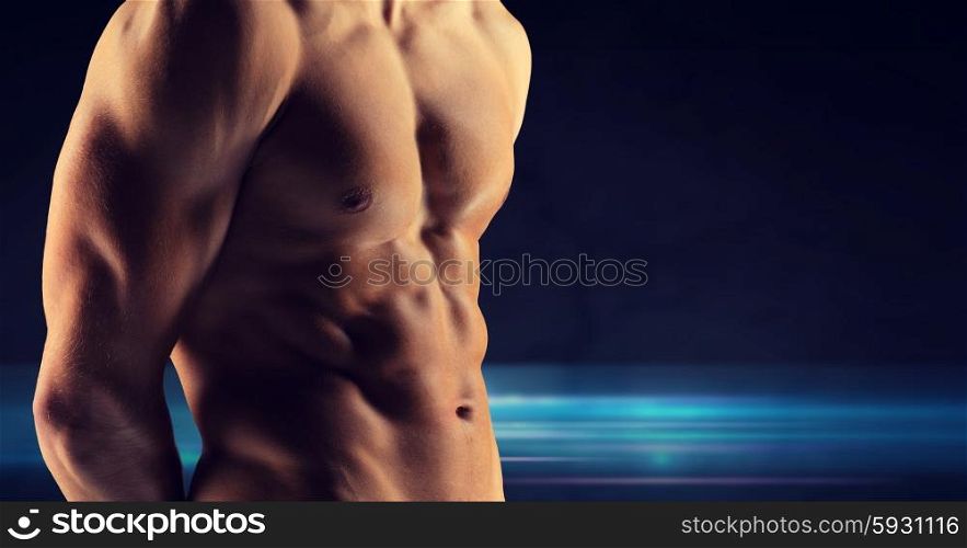 sport, bodybuilding, strength and people concept - close up of male bodybuilder bare torso over dark background
