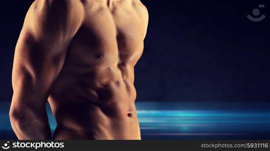 sport, bodybuilding, strength and people concept - close up of male bodybuilder bare torso over dark background