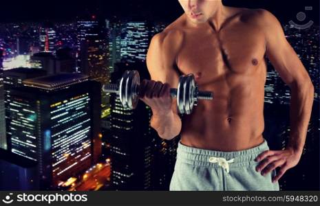 sport, bodybuilding, training and people concept - close up of young man with dumbbell flexing biceps over night city background