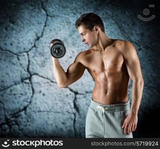 sport, bodybuilding, training and people concept - young man with dumbbell flexing biceps over concrete wall background