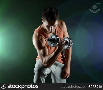sport, bodybuilding, training and people concept - young man with dumbbell flexing biceps over dark background