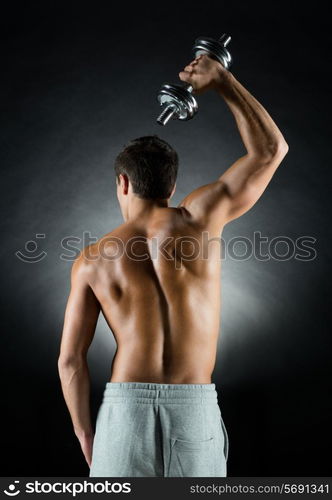 sport, bodybuilding, training and people concept - young man with dumbbell flexing muscles over gray background