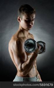 sport, bodybuilding, training and people concept - young man with dumbbell flexing muscles over gray background