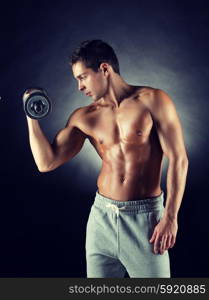 sport, bodybuilding, training and people concept - young man with dumbbell flexing muscles over gray background