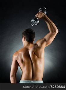 sport, bodybuilding, training and people concept - young man with dumbbell flexing muscles over gray background