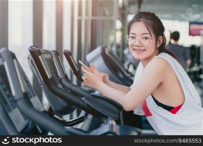 sport braces glasses teen girl with smartphone standing smile on treadmill in sportclub