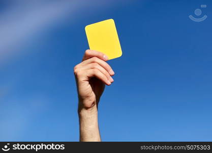 sport, caution, game and people - referee on football field showing yellow card. referee on football field showing yellow card